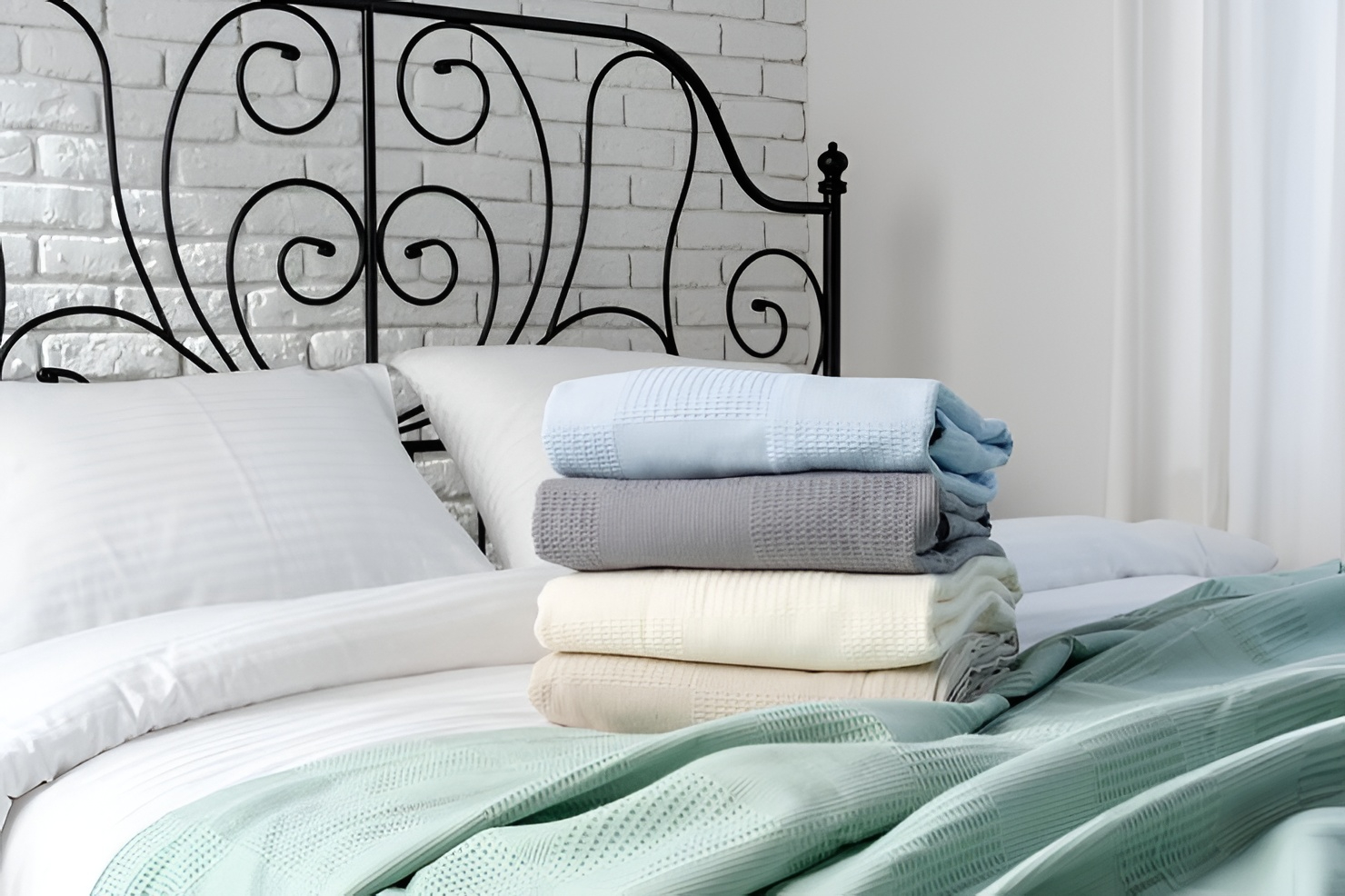 Fresh clean bedding arranged on bed